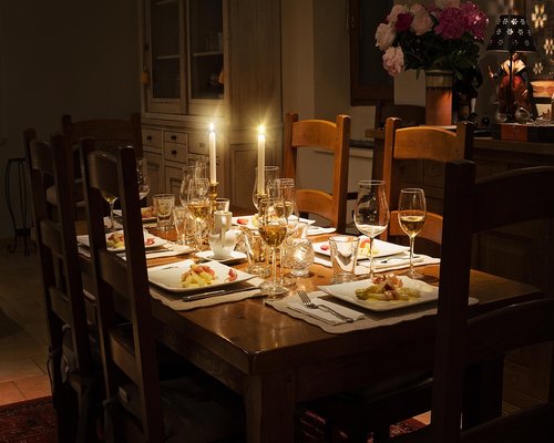 Family sitting around a dining table enjoying a meal together